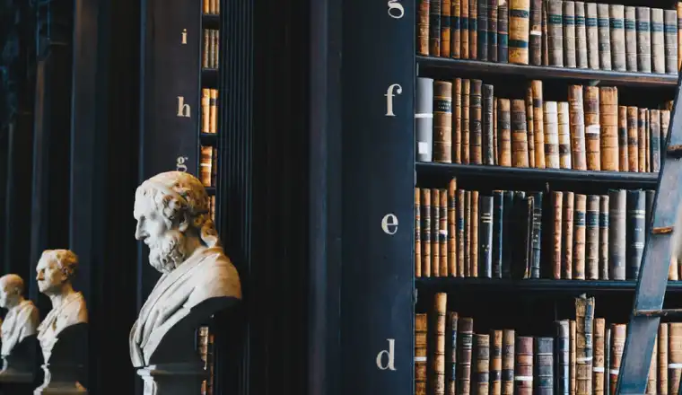 image of a library with old books and manuscripts and sculpture