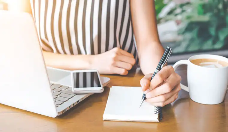 lady writing something on a notepad