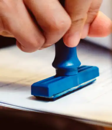image of a person stamping a legal document