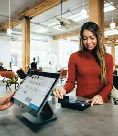 lady swiping her card on the pos machine at the counter