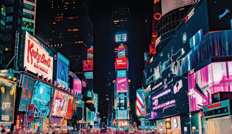neon branding lights on city buildings at night