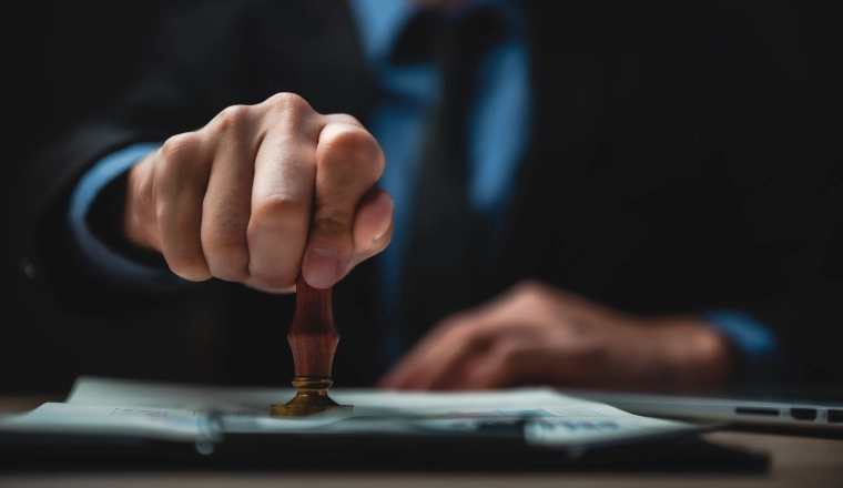 image of a person stamping the registered trademark seal