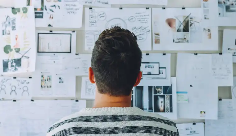 image of a startup owner looking at his business plans on the board