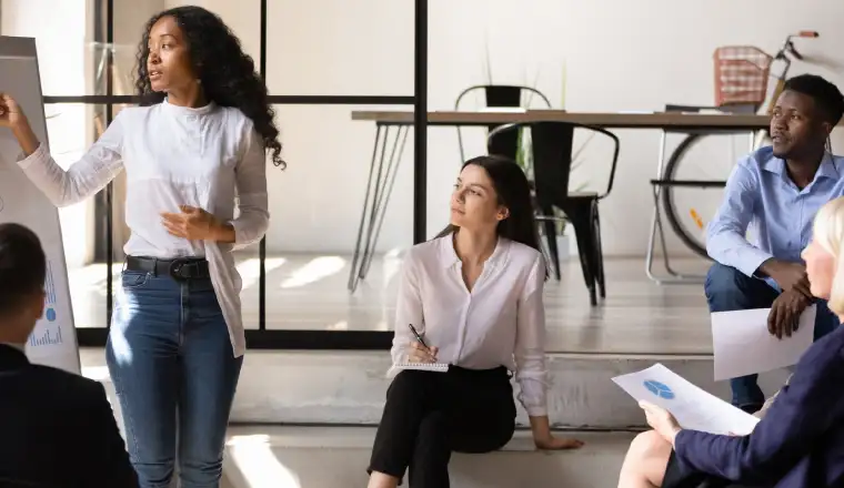 image of a young entrepreneur surrounded by a group of audience